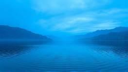 majestic acrylic installations, grand, creating a mosaic pattern, photorealistic, near a serene lake at dawn, highly detailed, rippling water reflections, 85mm telephoto lens, cool blue hues, early morning light, shot with a 16-35mm lens