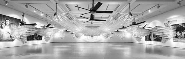 spectacular acrylic installations, jaw-dropping, sprawling across room, photorealistic, modern art gallery with high ceilings, highly detailed, ceiling fans rotating, 55mm lens, monochrome, spotlight focus, shot with an 85mm lens